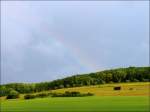 Ansatz eines Regenbogens fotografiert am 27.06.08 in Erpeldange/Wiltz. Leider verschwand die Sonne wieder, sodass der Regenbogen keine Chance hatte sich voll zu entwickeln. (Jeanny)