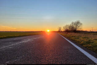Sonnenuntergang auf Asphalt, eingefangen beim Spaziergang zum 1.