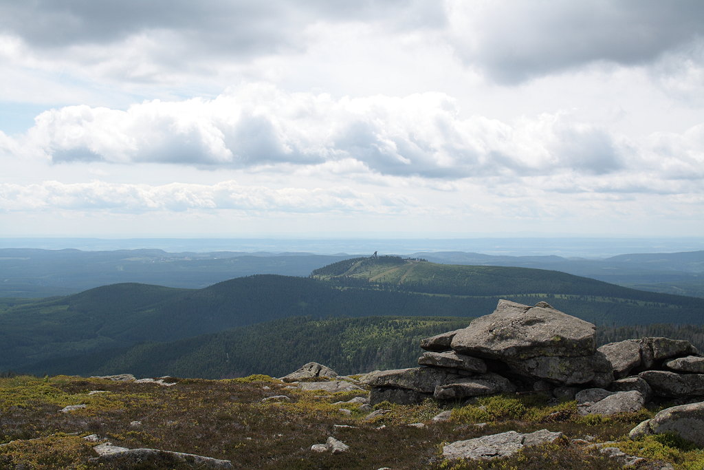 Schwere Wolken sind ber der Heidelandschaft des Brocken und dem Harz aufgezogen; Aufnahme um die Mittagszeit des 10.06.2012 vom Brockengipfelrundweg: Jenseits der Felsformation der  Teufelskanzel  geht der Blick ca. 100 - 150 km weit hinber zum Wurmberg, ber den Sdharz bis zur Hainleite und zum Thringer Wald in Thringen (zart unter den Wolken am Horizont).