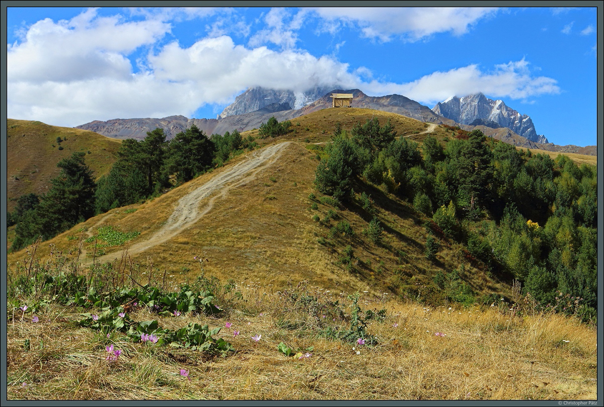 Das Kreuz von Mestia auf ca. 2200 m gewährt einen schönen Blick auf den Großen Kaukasus. In Bildmitte befindet sich der 4700 m hohe Ushba, dessen markante Doppelspitze sich hier bereits in den Wolken verbirgt. (bei Mestia, 14.09.2019)