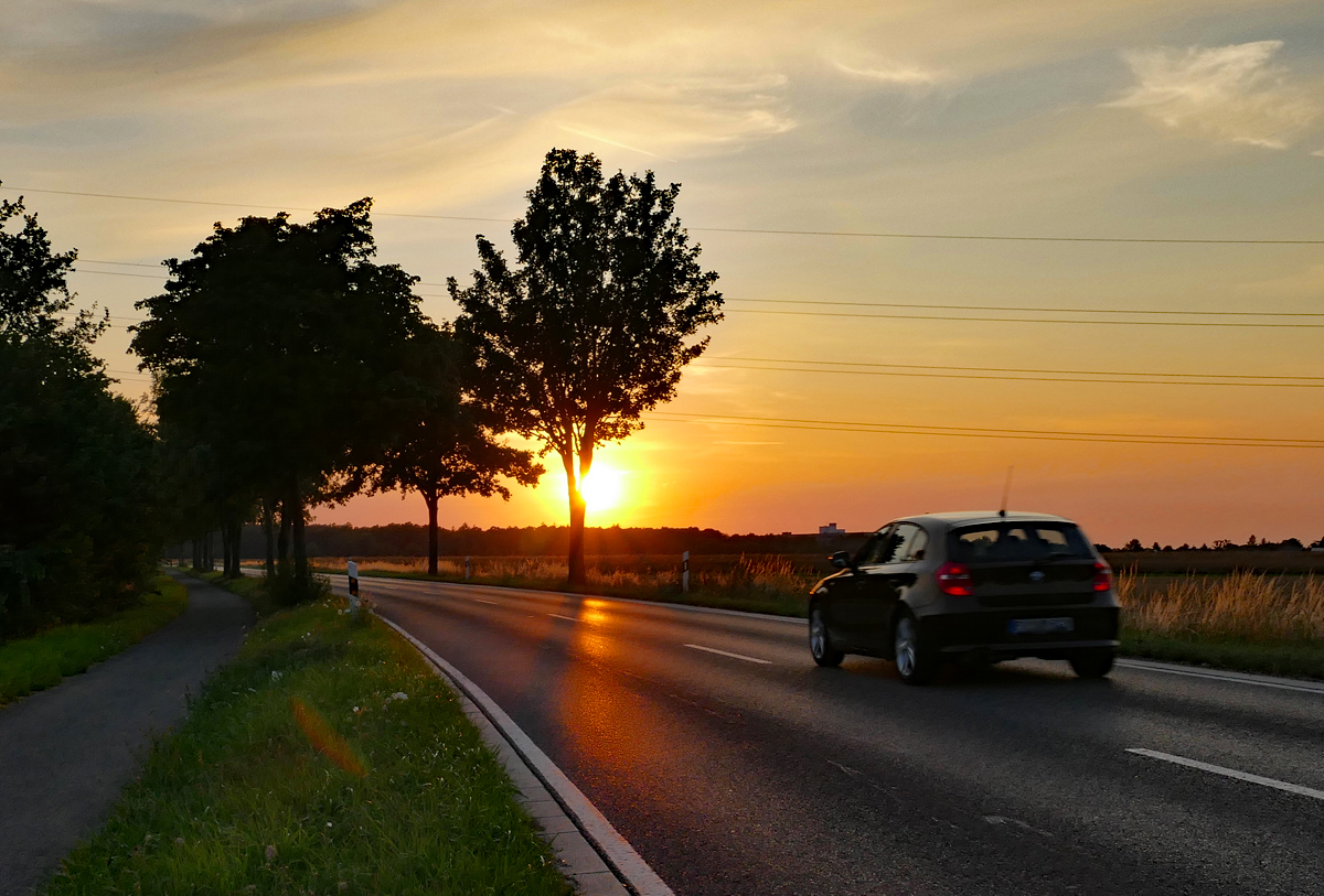 Sonnenuntergang mit durchfahrendem Auto bei Euskirchen - 13.07.2020