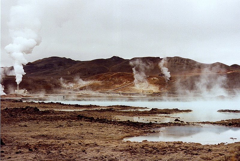 See mit warmen Wasser und im Hintergrund Solfatarenfelder mit Dampfsulen neben der Kieselgur-Fabrik (links) am Myvatn-See im Juni 1997. 