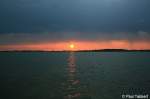 Zur Abwechslung mal ein Sonnenaufgang: Der Feuerball erhebt sich langsam ber der Insel Rgen und zieht eine schillernde Bahn im Strelasund. Aufgenommen am Morgen des 21. August 2009 im Stralsunder Freibad.

