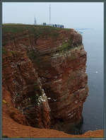 Der Lummenfelsen auf Helgoland ist mit nur 1,1 ha eines der kleinsten Naturschutzgebiete Deutschlands und Nistplatz zahlreicher Vögel. Im Hintergrund sind der Leuchtturm und der Sender Helgoland zu erkennen. (Helgoland, 13.04.2018)