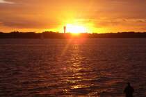 Sonneuntegan an der Kieler F�rde mit einem Leuchtturm (1)