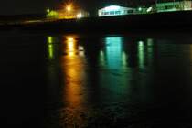 Farbenspiel bei Eyrichshof(bei Ebern)im Winter.Der Wiesengrund ist erst �berschwemmt,dann gefroren.Das kleine Industriegebiet spiegelt sich dann bei Nacht.